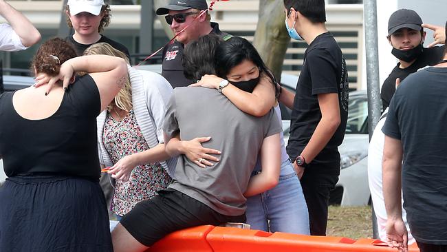 A couple reunites at Coolangatta on Sunday. Picture: Richard Gosling