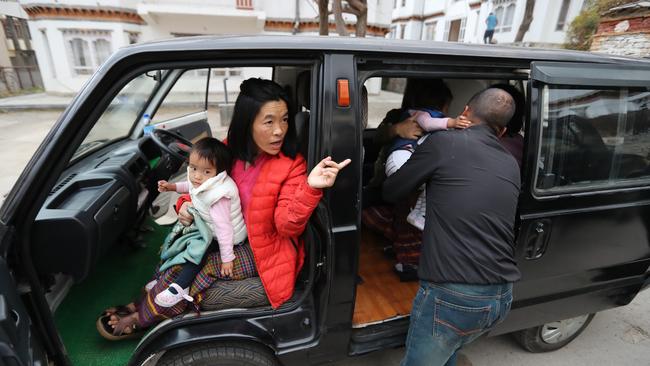 Leaving at dawn for the five-hour drive, mum Bhumchu holds Dawa while dad Sonam holds Nima. Picture: Alex Coppel