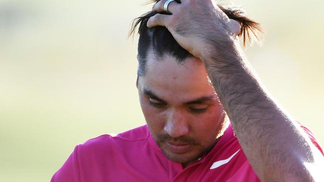 Jason Day of reacts after finishing on the 18th green.