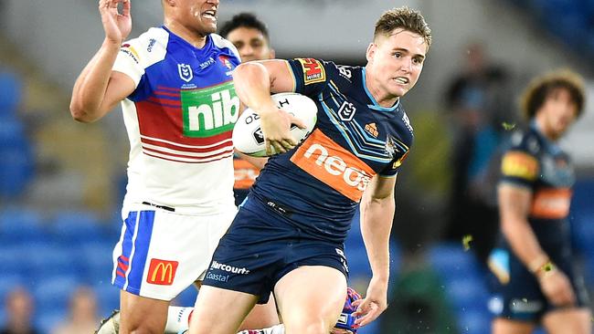 GOLD COAST, AUSTRALIA - SEPTEMBER 25:  AJ Brimson of the Titans evades the tackle of Kalyn Ponga of the Knights as he breaks away to score a try during the round 20 NRL match between the Gold Coast Titans and the Newcastle Knights at Cbus Super Stadium on September 25, 2020 in Gold Coast, Australia. (Photo by Matt Roberts/Getty Images)