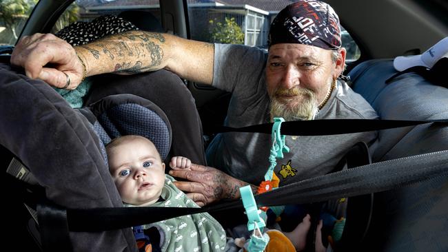 Craig Soden with four-month-old George is living out of his car in a Brisbane park, Thursday, August 18, 2022 – Picture: Richard Walker