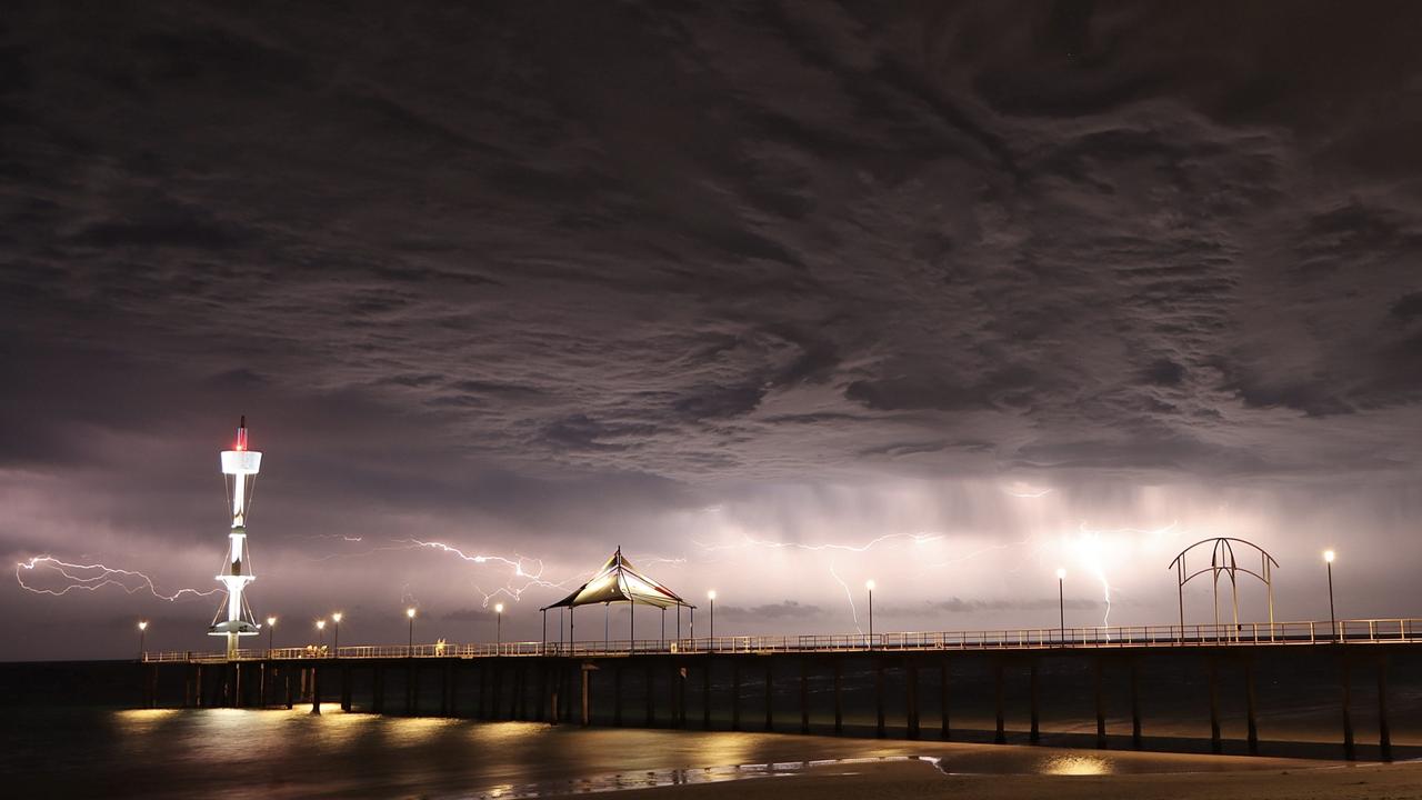 Brighton Jetty in Adelaide sees a dramatic display of lightning as storms roll in. Picture: Rick Beal