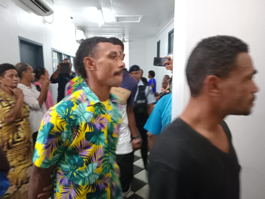 Ilaisa Tanoa, 24, in coloured shirt, is escorted to a holding cell at Nadi Magistrate's Court on Monday.