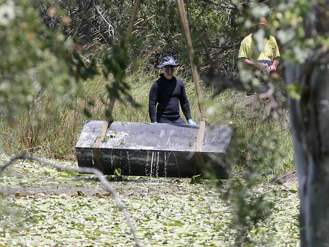 Toolbox murder -  Police retrieve a metal box from a dam near Srubby Creek in Kingston, double murder Logan. Pic Jono Searle.