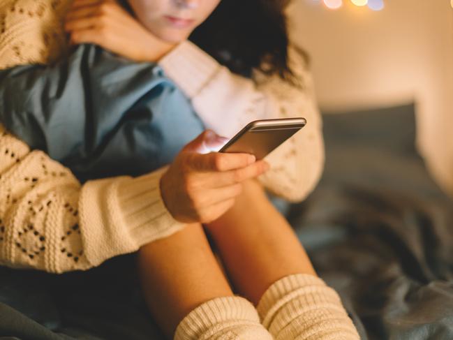 Girl texting on smartphone at home generic. Photo: iStock