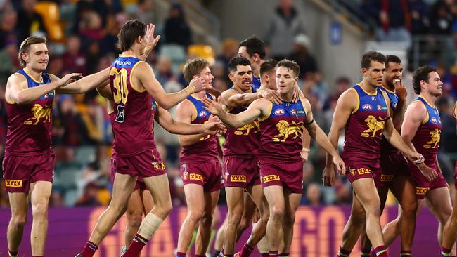 The Lions get around Lincoln McCarthy after his goal. Photo by Chris Hyde/AFL Photos/via Getty Images