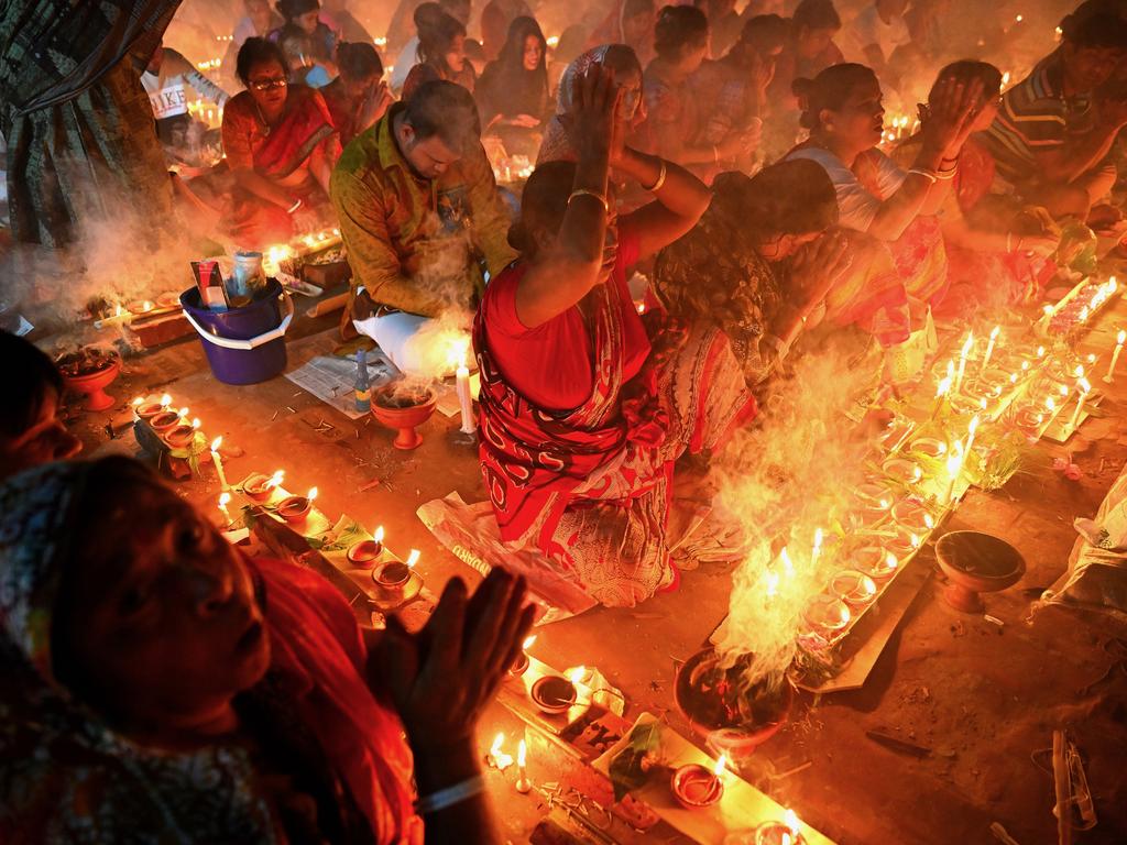 A woman prays during a Hindu religious festival known as Rakher Upobash in Bangladesh. Devotees follow Baba Loknath’s instruction to fast on Saturdays and Tuesdays in the month of Kartik to ward off cholera and smallpox. They gather at the ashram, lighting lamps and breaking their fast in the evening. Picture: Md Mahabub Hossain Khan/Pink Lady® Food Photographer of the Year