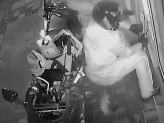 Police have released CCTV footage of two men in motorbike helmets breaking into a popular southern suburbs pizza bar before setting it alight. Picture: SA Police