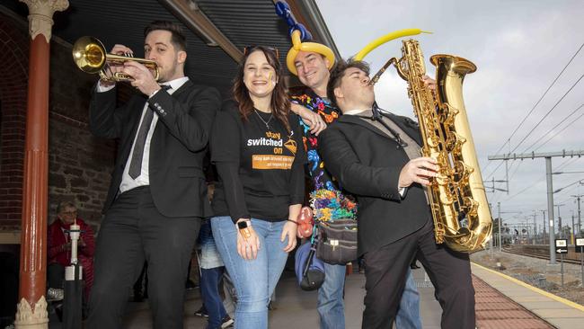 The Baker Boy Band Members Emile Ryjoch and Luke White play on either side of Teresa Hollinshead from Dept of Transport and Bring me Magic’s Greg Brusic entertain the crowd. Picture Emma Brasier