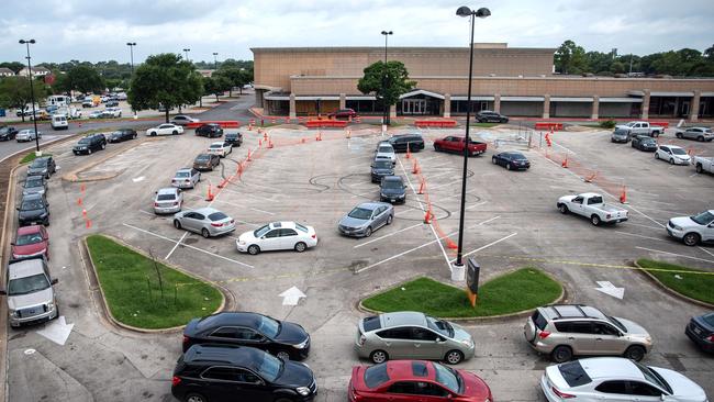 People sit in their cars and wait in line at a COVID19 testing centre in Austin, Texas, which has had an explosion in cases.