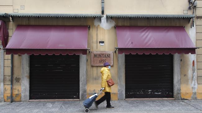 A woman walks in Codogno, Italy. The northern Italian town that recorded Italy’s first coronavirus infection has offered a virtuous example to fellow Italians, now facing an unprecedented nationwide lockdown, that by staying home, trends can reverse. Picture: AP