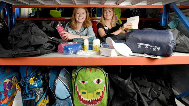 Tayla Hope and Kate McLaughlin put together backpacks for young homeless people. Picture: Naomi Jellicoe