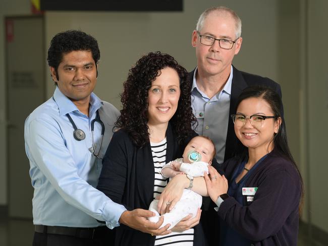 Doctors from Campbelltown Hospital’s emergency department with mum Cerys and baby Oliver whose life they helped save last year. Picture: Simon Bullard