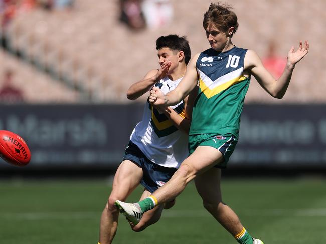 Thomas McGuane kicks the ball under pressure from Felix Kneipp. Picture: Daniel Pockett/AFL Photos/via Getty Images