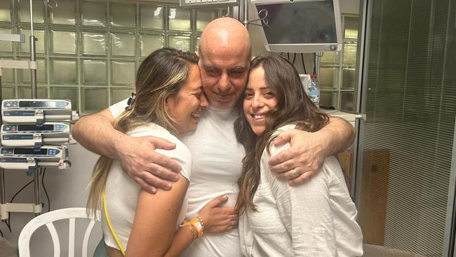 Shlomi Ziv, a rescued hostage embraces his sister, Revital Nasi, and his cousin, Liat Ariel. Picture: Reuters