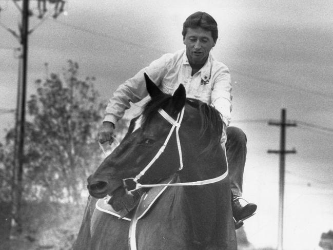 Jockey John Letts takes his 1968 Adelaide Cup-winning mount, Rain Lover, for a quick ride at Morphettville Racecourse in 1988.