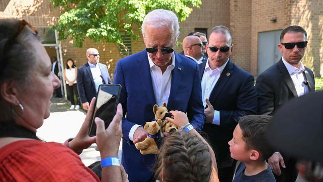 US President Joe Biden gives children stuffed animal toys, modelled after the Biden family dog Commander, during a campaign stop in Harrisburg, Pennsylvania, on Sunday. Picture: AFP