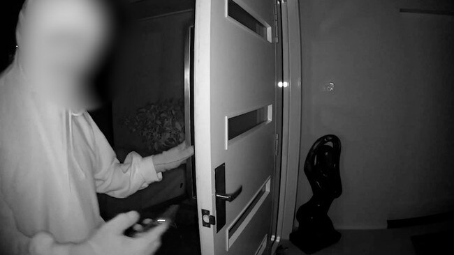 Home security vision taken during a break-in at the home of well known Newcastle businessman Glenn Geary show one of the intruders with his phone ready to record. Pictures: Supplied