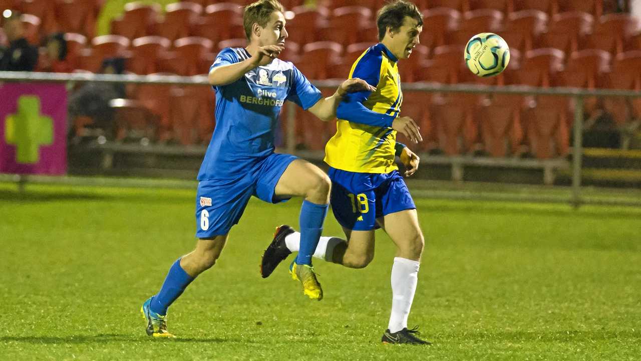 UNDER PRESSURE: South West Queensland Thunder captain Jacob Bigby (left) battles for control against his Brisbane Strikers opponent. The Thunder face Olympic FC on Saturday. Picture: Kevin Farmer