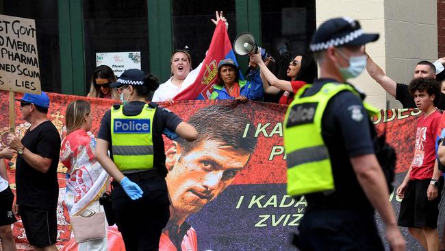 Pro-Djokovic protesters gather outside the Melbourne hotel on Friday where the world No.1 is holed up after having his visa cancelled. Picture: AFP