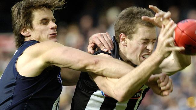 Jason Saddington (left) spoils Collingwood’s Nick Maxwell. Picture: AAP Image/Martin Philbey