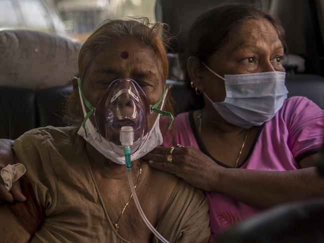 NEW DELHI, INDIA - APRIL 24: Patients who are infected with Covid-19 coronavirus can be seen wearing Oxygen masks as free Oxygen was supplied as a part of public service for the people in need by a Gurdwara or a Sikh Holy place amid the rising concerns over lack of Oxygen on April 24, 2021 in New Delhi, India. With recorded cases crossing 300,000 a day, India has more than 2 million active cases of Covid-19, the second-highest number in the world after the U.S. A new wave of the pandemic has totally overwhelmed the country's healthcare services and has caused crematoriums to operate day and night as the number of victims continues to spiral out of control. (Photo by Anindito Mukherjee/Getty Images)