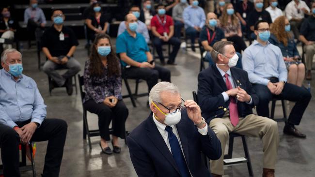 People wait for US President Donald Trump to speak at a Honeywell International Inc. factory during his visit.