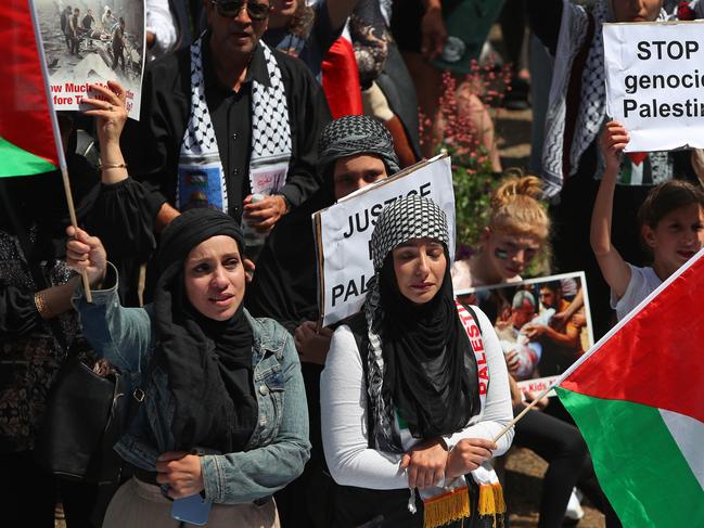 SYDNEY, AUSTRALIA - OCTOBER 21: Palestine supporters gather during a protest at Town Hall on October 21, 2023 in Sydney, Australia. On October 7, the Palestinian militant group Hamas launched the largest surprise attack from Gaza in a generation, sending thousands of missiles and an unknown number of fighters by land, who shot and kidnapped Israelis in communities near the Gaza border. The attack prompted retaliatory strikes on Gaza and a declaration of war by the Israeli prime minister. (Photo by Lisa Maree Williams/Getty Images)