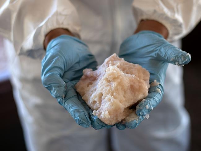 A Mexican Army expert shows crystal meth paste at a clandestine laboratory near la Rumorosa town in Tecate. Picture: AFP