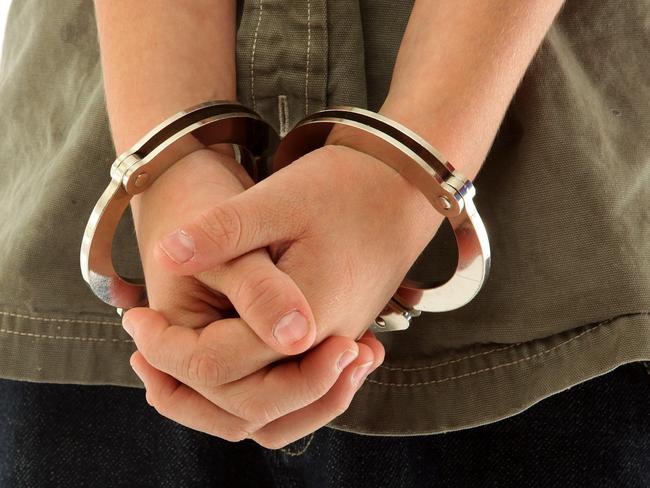 Child's hands handcuffed, juvenile crime.