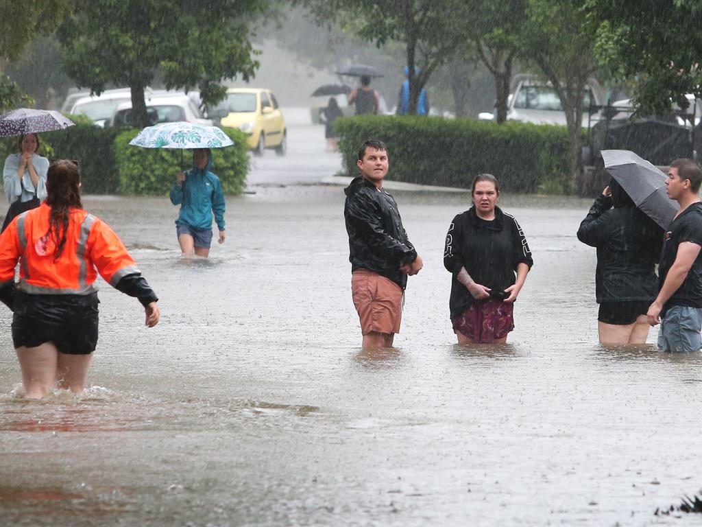 Residents in the floodwaters of Bowen St, Windsor. Picture: Anthony Reginato