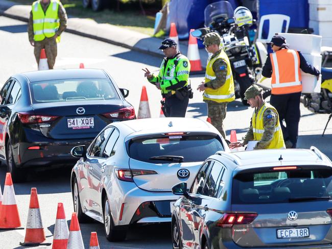 Police and the Army at the Queensland border on the Gold Coast Highway.Picture: NIGEL HALLETT