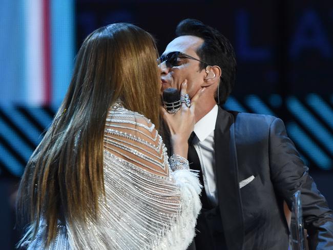 Lopez and Anthony share a quick kiss.