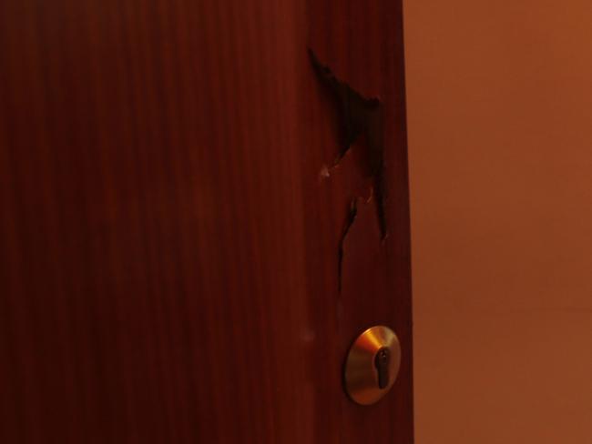 A broken door lies open after a police raid on the house of the Oukabir family. Picture: AP