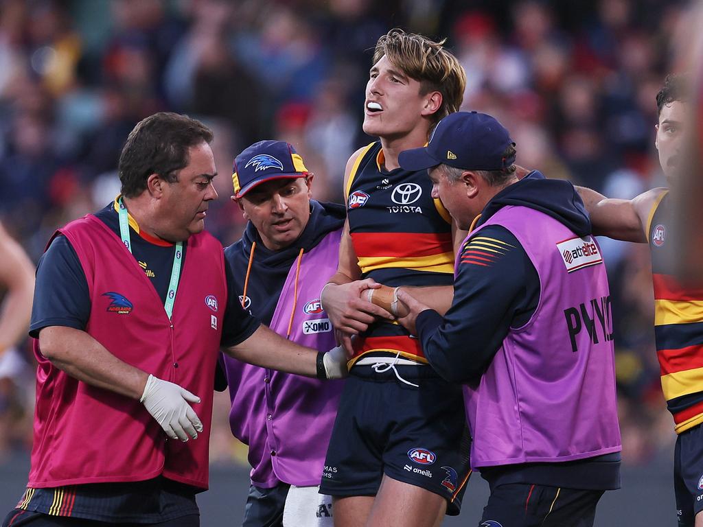 Josh Worrell comes off injured on Sunday. Picture: James Elsby/AFL Photos via Getty Images.