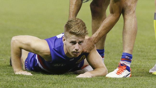 Lachie Hunter gets up after being coat-hangered by Lindsay Thomas. Picture: Michael Klein