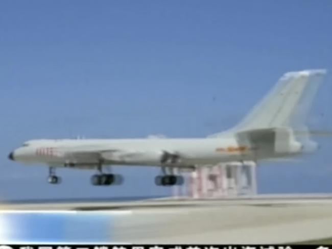 In this image taken from a May 19, 2018, video footage run by China's CCTV via AP Video, a Chinese H-6K bomber aircraft is seen flying along a runway in the South China Sea. The Chinese air force has landed long-range bombers for the first time at an airport in the South China Sea, a state newspaper said Saturday, in a move likely to further fuel concerns about Beijing's expansive claims over the disputed region.(CCTV via AP Video)