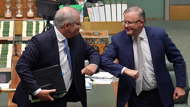 Prime Minister Scott Morrison and Leader of the Opposition Anthony Albanese bump elbows after delivering their Christmas messages in the House of Representatives at Parliament House last week.