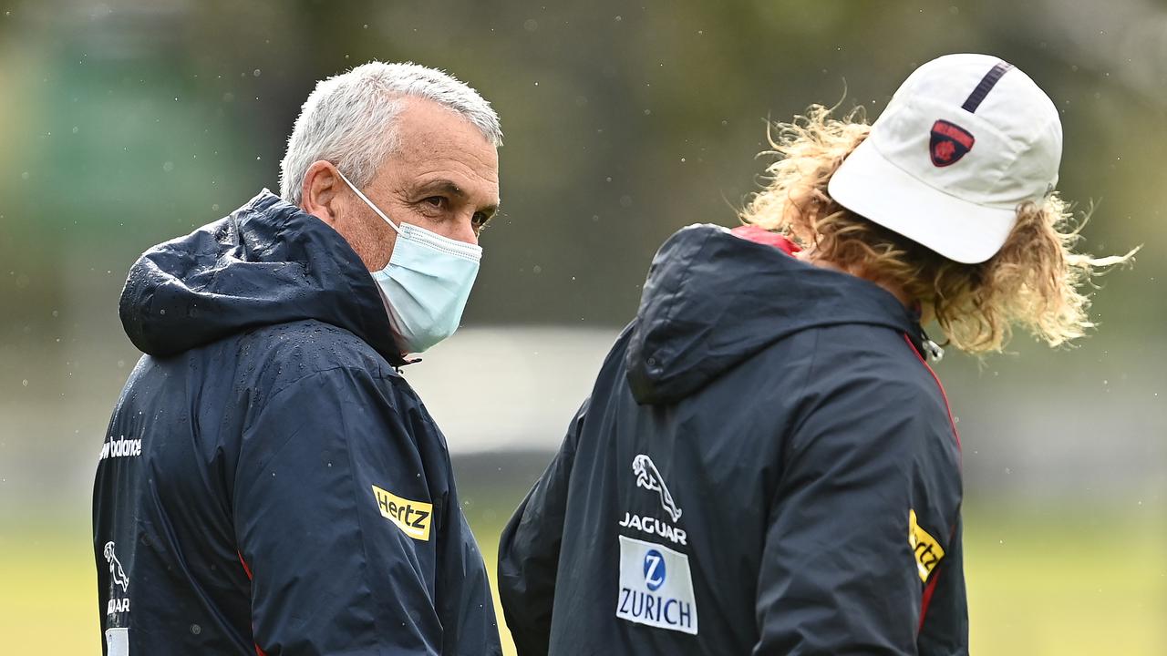 MELBOURNE, AUSTRALIA – JUNE 08: Jayden Hunt and Mark Williams the assistant coach of the Demons share a laugh during a Melbourne Demons AFL training session at Gosch's Paddock on June 08, 2021 in Melbourne, Australia. (Photo by Quinn Rooney/Getty Images)