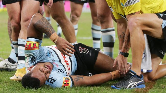 Sione Katoa of the Sharks is assisted after sustaining a knee injury (Photo by Matt King/Getty Images)