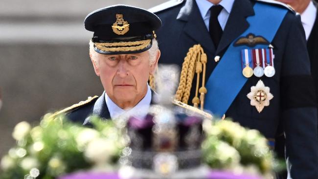 King Charles III walks behind the coffin of Queen Elizabeth II, adorned with a Royal Standard and the Imperial State Crown and pulled by a Gun Carriage of The King's Troop Royal Horse Artillery.