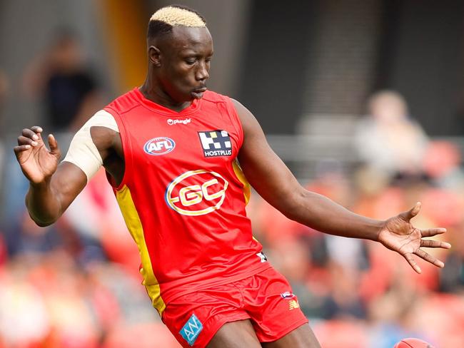 GOLD COAST, AUSTRALIA - JULY 31: Mabior Chol of the Suns kicks the ball during the 2022 AFL Round 20 match between the Gold Coast Suns and the West Coast Eagles at Metricon Stadium on July 31, 2022 in Gold Coast, Australia. (Photo by Russell Freeman/AFL Photos via Getty Images)