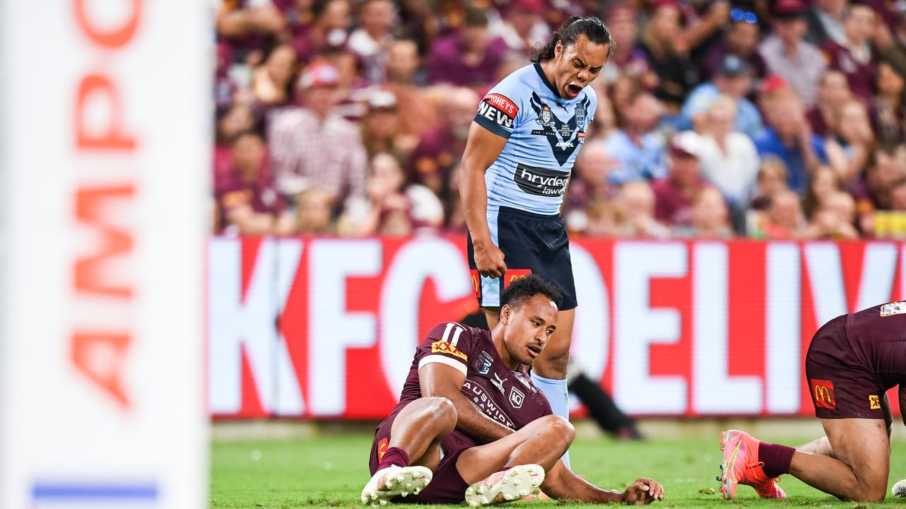 Blues five-eighth Jarome Luai stands over Maroons forward Felise Kaufusi