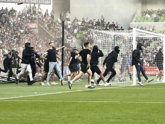 MELBOURNE, AUSTRALIA - DECEMBER 17: Fans storm the pitch in protest during the round eight A-League Men's match between Melbourne City and Melbourne Victory at AAMI Park, on December 17, 2022, in Melbourne, Australia. (Photo by Darrian Traynor/Getty Images)