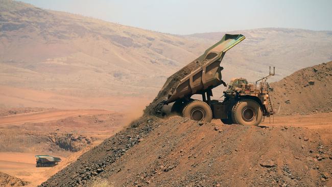 An autonomous haul truck dumps rock in the mine pit of Rio Tinto’s Gudai-Darri iron ore mine in the Pilbara. Picture: Bloomberg