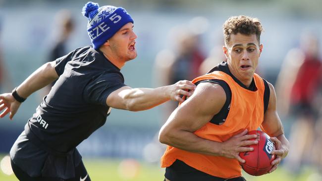 Nic Newman tackles teammate Ed Curnow at training.