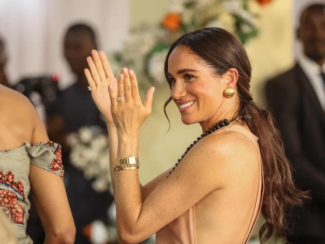 Meghan Markle flashes the flesh during her visit to Nigeria. Picture: AFP