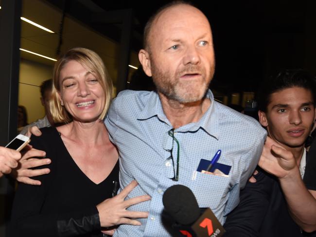 60 Minutes journalist Tara Brown and producer Stephen Rice are mobbed by journalists as they arrive at Sydney International Airport. Picture: AAP Image/Dean Lewins