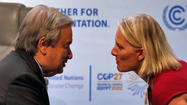 United Nations Secretary General Antonio Guterres shakes hands with the chair of the United Nations Secretary-General's High-level Expert Group on Net-Zero Commitments, Catherine McKenna, during a UN expert panel at the COP27 climate conference.