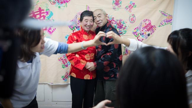 An older couple get their wedding photos taken.